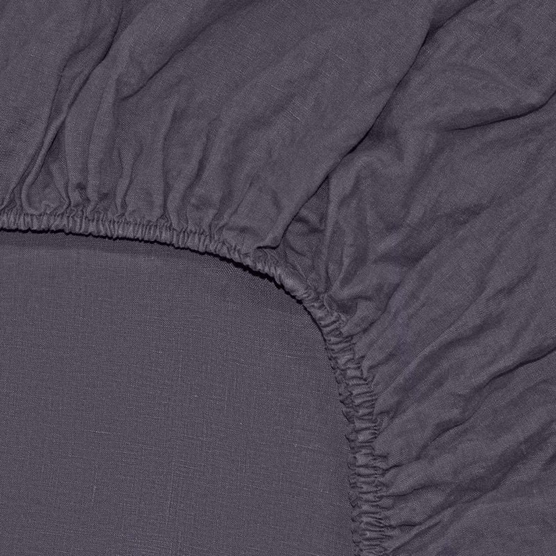 Inside corner of anthracite gray linen fitted sheet