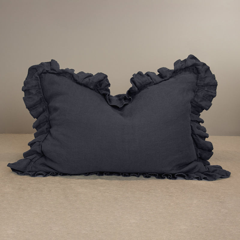 Linen pillow in anthracite gray pillowcase with ruffles crumpled in the middle